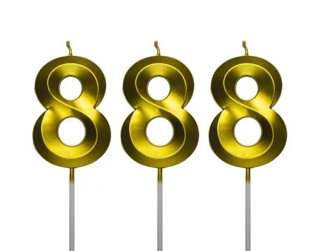 Number eight hundred eighty eight shaped golden metallic birthday candles i.. Stock Photos