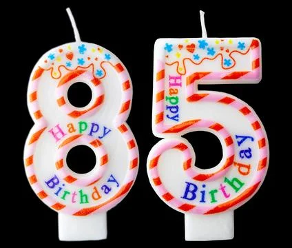 Number eighty five shaped birthday candle with colorful sprinkles and Happy.. Stock Photos
