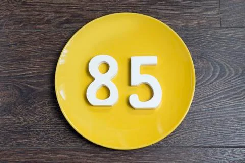 The number eighty-five on the yellow plate. Stock Photos