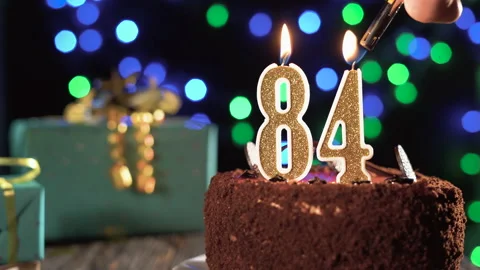 Number eighty-four birthday candle on a sweet cake on the table, 84th birthday 스톡 동영상 169625819