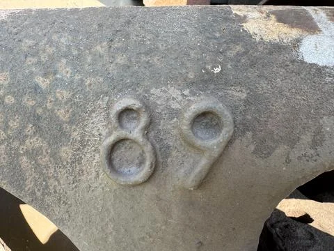 Number eighty nine embossed on aged rusted metal industrial surface Foto stock