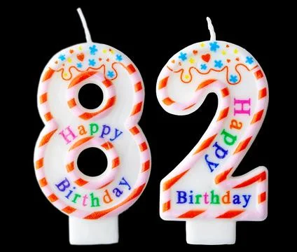 Number eighty two shaped birthday candle with colorful sprinkles and Happy .. Stock Photos
