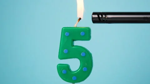 Number five birthday candle being lit with a lighter Video stock 342176205