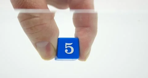 Number five on dice blue held in hand isolated on white in water Stock Footage 219520741