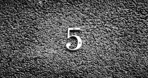 Number five on the wall of a house Stock Photos
