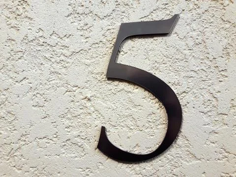 Number five on the wall. Stock-Fotos