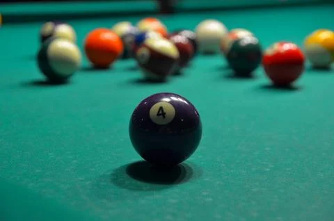 Number four billiard ball on pool table Stock Photos