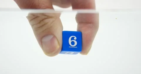Number six on blue dice being held by hand in the water isolator white Stock-Footage 219520790