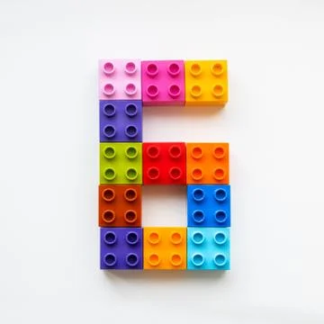 Number Six made of colorful constructor blocks. Toy bricks lying in order, ma Stock Photos