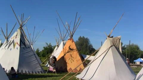 A number of tepees on meadow 스톡 사진