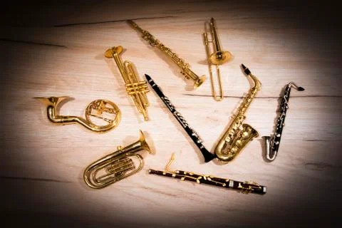 A number of toy wind instruments  lying on a wooden board Stock-Fotos