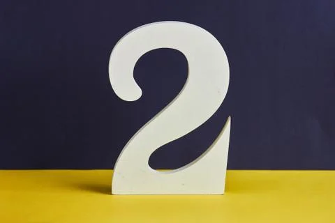 Number two made from wood on black and yellow background Stock Photos