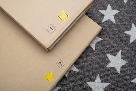 Numbered Cardboard Boxes on Star Patterned Gray Carpet Stock Photos