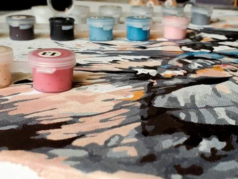 Numbered containers with paints on a canvas background Stock Photos