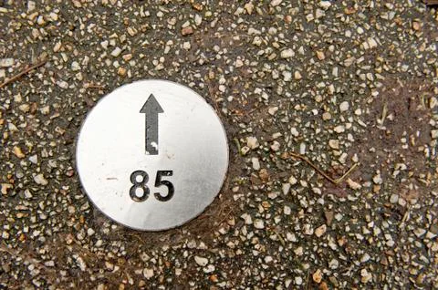 Numbered direction plate in pavement Stock Photos