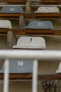 Numbered plastic stadium seats in empty bleachers Stockfoto's