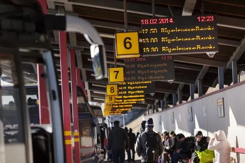 Numbered platforms for bus stops and people around at the bus station in Riga Stock Photos