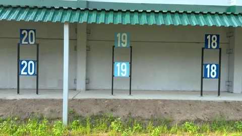 Numbered targets on a shooting range under a green metal roof Vídeo Stock 337063509