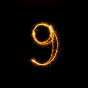 Numbers 0 to 9 created using a sparkler on black Stock Photos