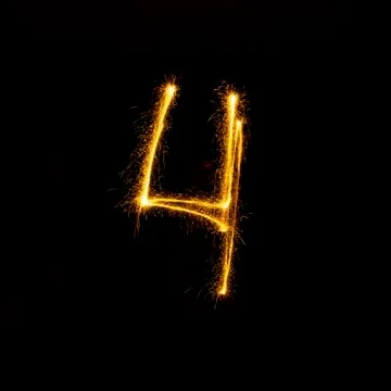 Numbers 0 to 9 created using a sparkler on black Stock Photos