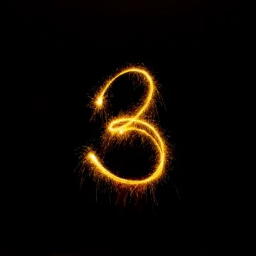 Numbers 0 to 9 created using a sparkler on black Stock Photos