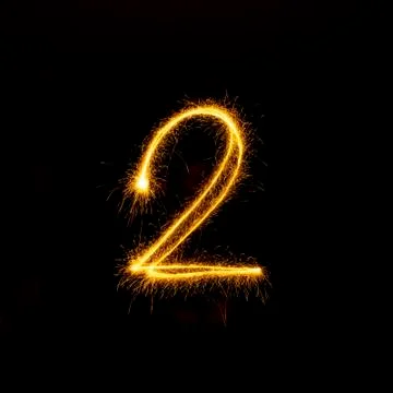 Numbers 0 to 9 created using a sparkler on black Stock Photos