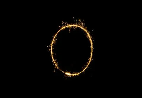Numbers 0 or zero Sparkler firework light isolated on black background Stock Photos
