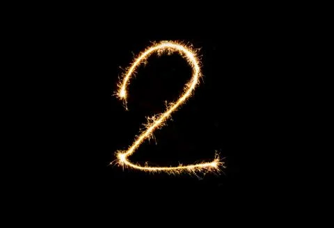 Numbers 2 or two Sparkler firework light isolated on black background Stock Photos