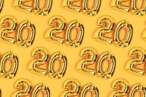 Numbers 20 golden balloons pattern. Twenty years anniversary celebration. Stock Photos