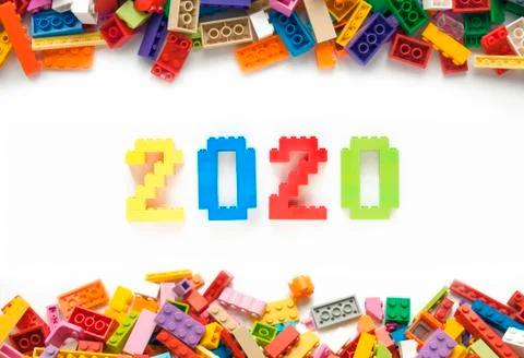 Numbers 2020 made from toys blocks with scattered blocks on white background Stock Photos