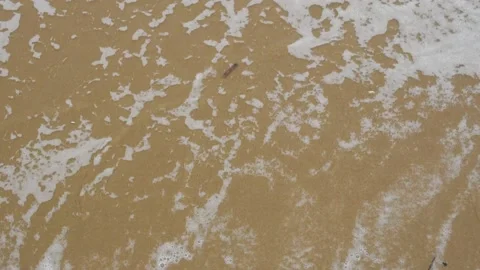 Numbers 2022 written on the sand washed away by the wave. New Year 2023 is Stock Footage 220596366