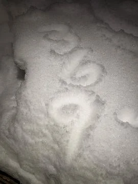 The Numbers 3 6 9 Drawn into Fresh White Snow Close Up at Night 库存照片