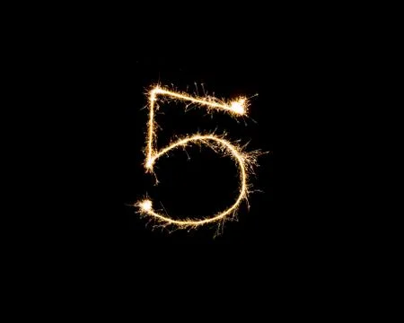 Numbers 5 or five Sparkler firework light isolated on black background Stock Photos