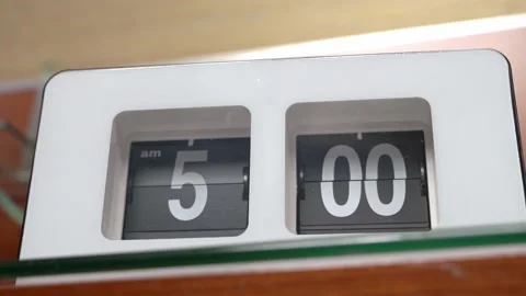 The numbers on dial of electronic alarm clock change, showing evening or early Stock Footage 157701561