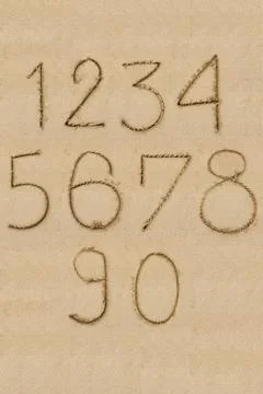 Numbers one to zero written on sand Foto stock