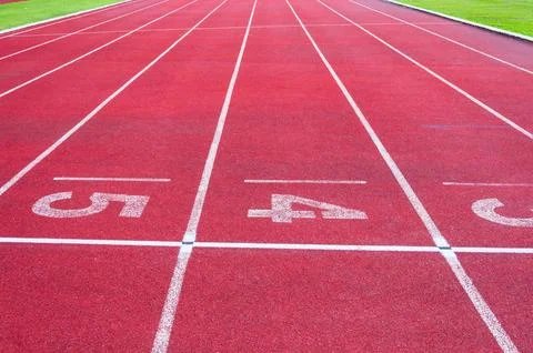 Numbers starting point on red running track,running track and green grass,D.. Stock Photos