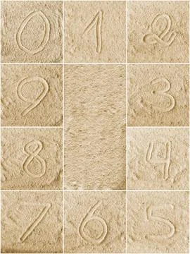 Numbers written on a sand Stock Photos