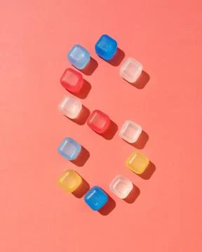 Numeral pattern six from colorful plastic ice cubes on a background in a color Foto stock