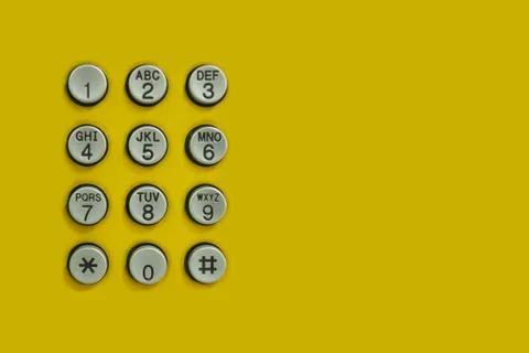 Numeric keypad of phone on the yellow background. 스톡 사진