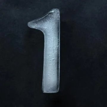 Numeric value, numbers made out of ice isolated on dark studio background 스톡 사진