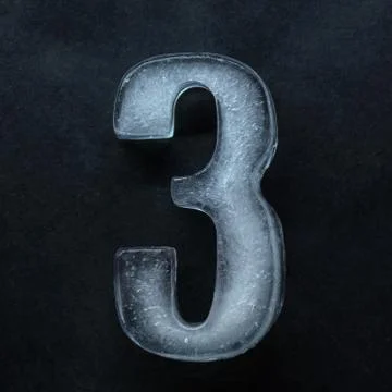 Numeric value, numbers made out of ice isolated on dark studio background 스톡 사진