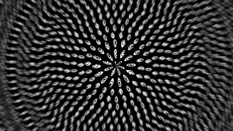 Numerous abstract hypnotic eye patterns radiating outward on a black background Stock Footage 280641486