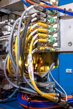 Numerous cables plugged into electronic machine Stock-Fotos