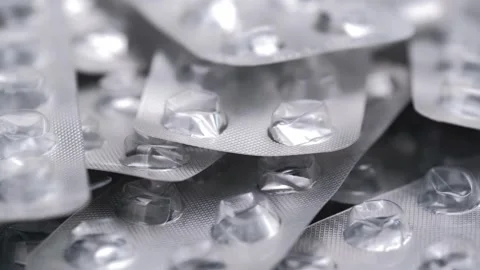 Numerous empty empty blister packs pills rotating slowly. closeup. Stock Footage 320215639