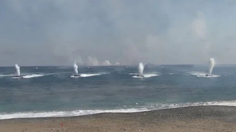Numerous explosions in the sea close to beach  Vídeos de archivo 84016893