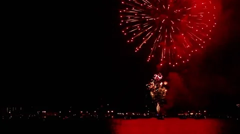 Numerous fireworks going off repeatedly over water Stock Footage 40648028