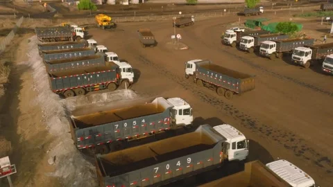 Numerous heavy dump trucks operate efficiently at the extensive Thar mining Stock Footage 337907958