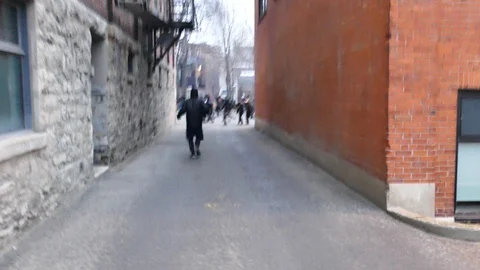 Numerous individuals running away from police Stock Footage 114762839