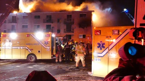 Numerous intervenants helping to transport fire victim Stock Footage 105281201