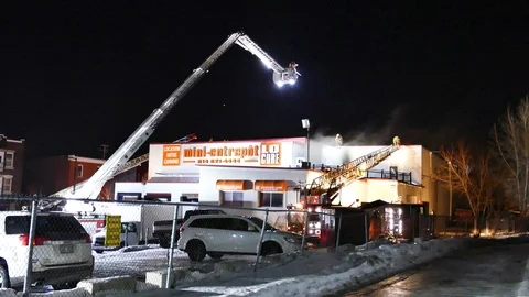 Numerous ladders erected at industrial fire Stock Footage 104233671